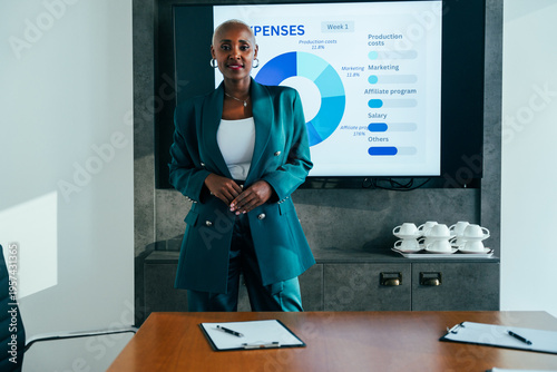 African american businesswoman standing in corporate board meeting