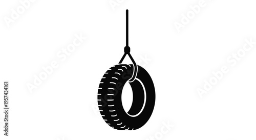 Hanging tire swing depicted in a stark black silhouette