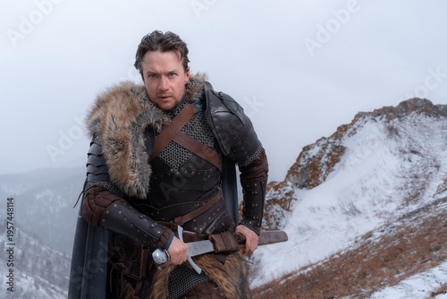 A rugged warrior stands resolute against a bleak, snowy landscape, sword at his hip and fur-trimmed armor shielding him from the elements.