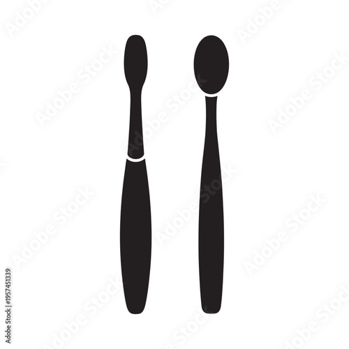 Two black silhouettes of cosmetic brushes stand vertically on white