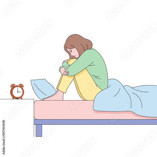 Young woman sitting on bed with knees pulled to chest in morning  