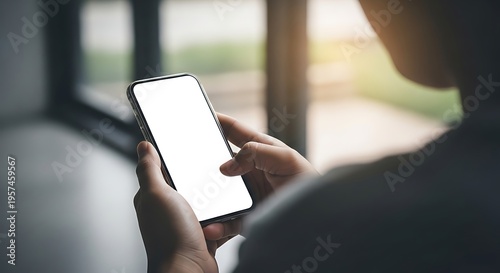 Person holding a smartphone with a blank screen