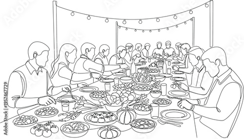 group of people sitting around a table with food
