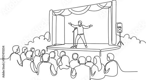 man on stage performing in front of audience