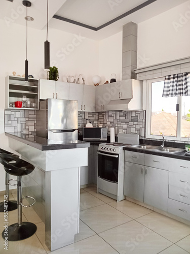 Clean kitchen area with bar counter and appliances