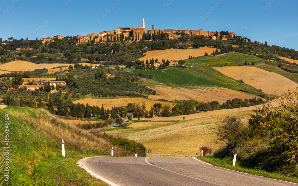 Fototapeta premium Pienza townscape and winding road through Val d'Orcia landscape, Italy.