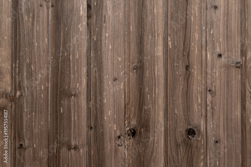 Close-up view of weathered wooden fence planks revealing grain, knots and dis...