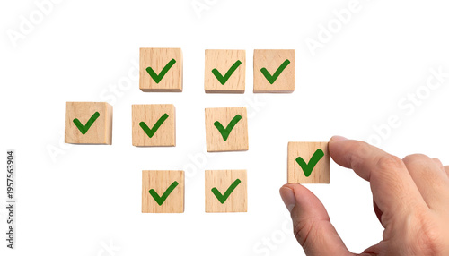 Hand places a checkmark block, completing a series of others. Black background