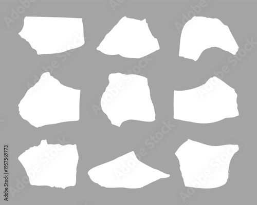 Collection of nine irregular white shapes on grey background