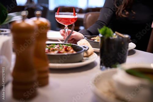 Εκτύπωση καμβά Adult woman enjoying festive cocktail at restaurant table