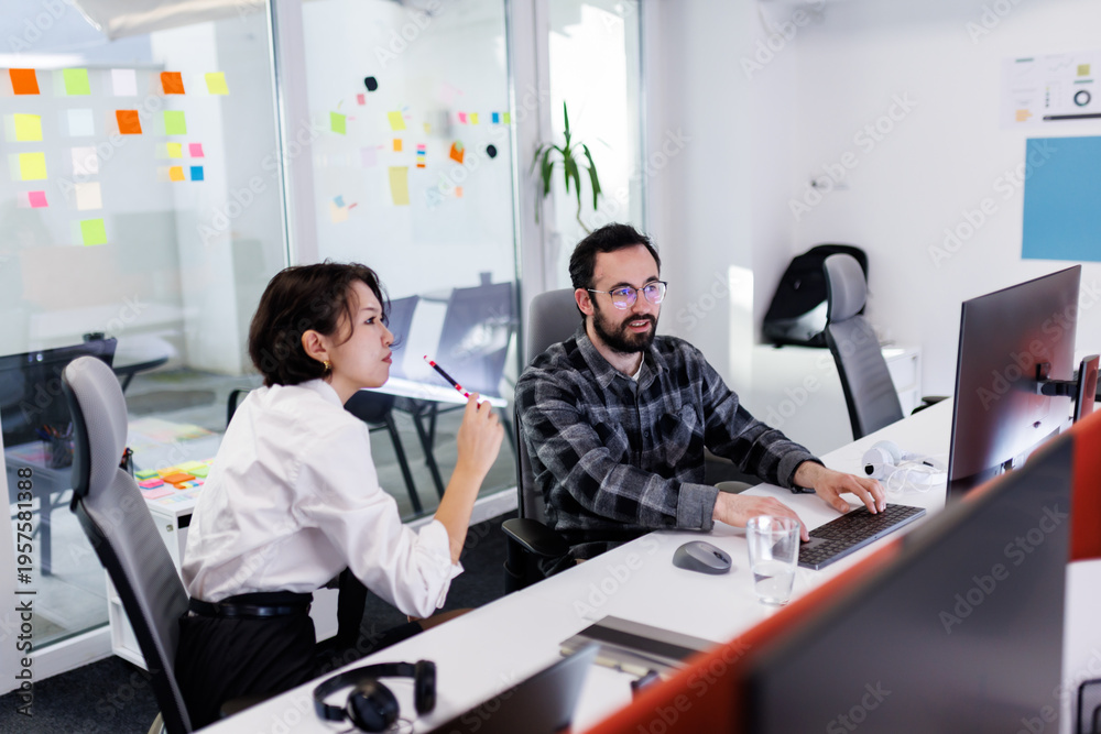 Fototapeta premium Business professionals collaborate in a modern office space, focusing on tasks while utilizing technology during a productive work session