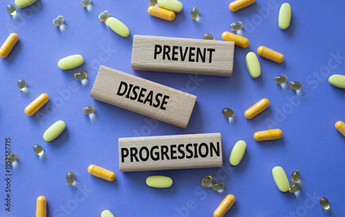 Prevent Disease Progression symbol. Concept words Prevent Disease Progression on wooden blocks. Beautiful purple background with pills. Healthcare and Prevent Disease Progression concept. Copy space.