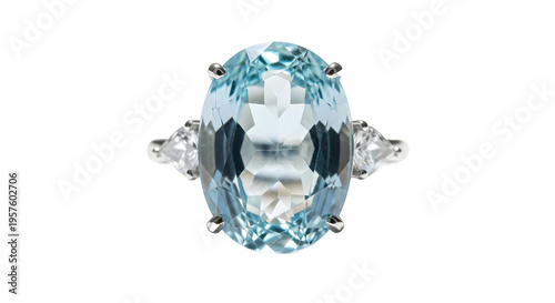 A large oval aquamarine gemstone ring with two trapezoid cut diamonds on a black background