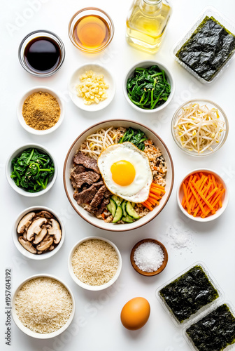 Korean bibimbap bowl with beef fried egg and vegetables surrounded by ingredients like rice spinach carrots and sesame oil.