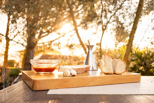 Rustic bread with tomato, oil and garlic on board