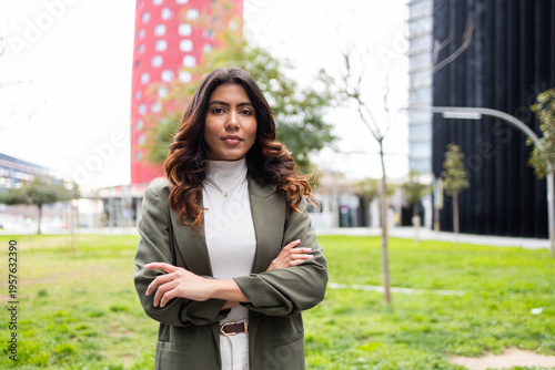 Confident businesswoman standing in modern urban setting