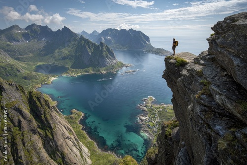 Hiker atop mountain overlooking scenic landscape with water and mountains