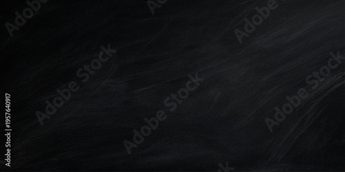 A textured vintage black chalk board with a dark grunge surface and light smoke patterns on a blank grey chalkboard backdrop featuring a rough wall design and an alpha channel