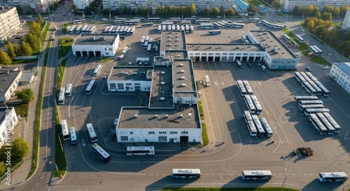 Busy Urban Bus Depot With Rows Of Buses Parked And Buildings