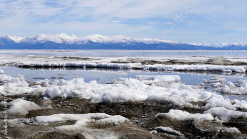 The icy shore of Lake Baikal in Russian Siberia in late spring. The northernmost point of Lake Baikal is located in the small town of Nizhneangarsk.
