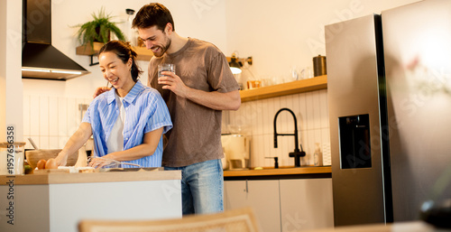 Couple cooking together in a modern kitchen during the day