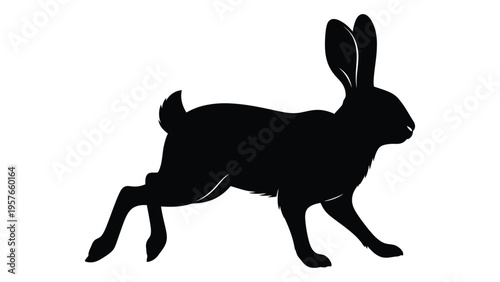 A sleek black silhouette of a rabbit in mid leap showcasing its dynamic form