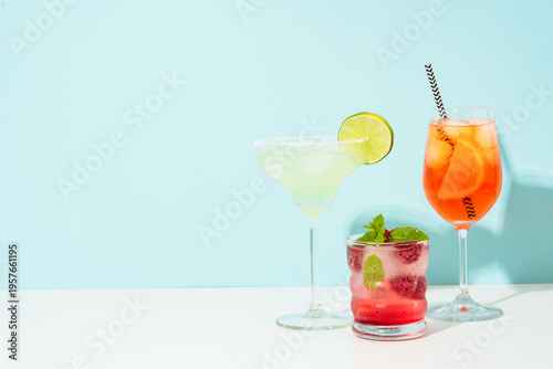 Margarita, Aperol Spritz and strawberry mojito at blue background.