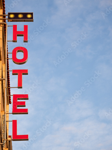 Hotel sign on blue sky background