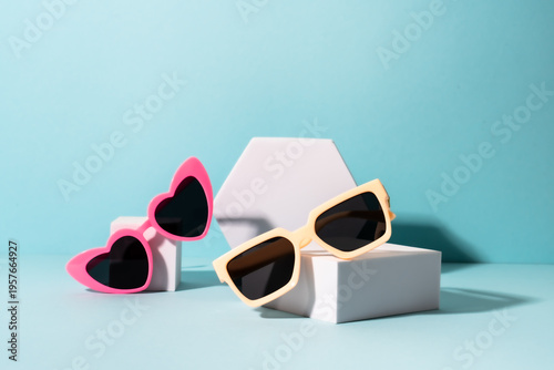 Bilde på lerret Sunglasses on white podium with sunny shadows.