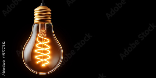 Glowing Edison light bulb on black background