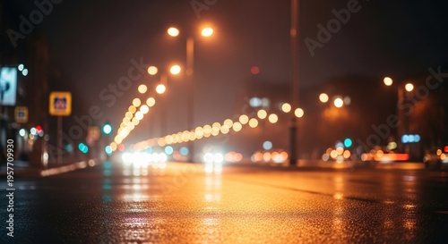 Blurred night city street with car lights and reflections on wet asphalt after rain.