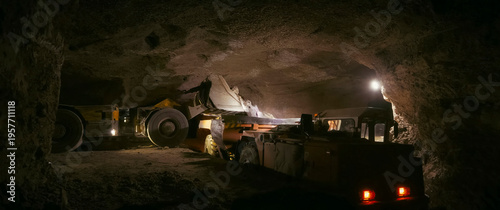 Slika na platnu mining bulldozer pours gold ore into the body of a mine dump truck