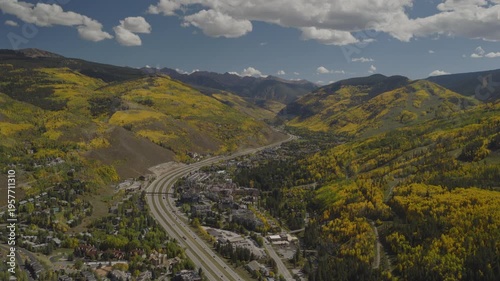 An aerial flyover near Vail, CO with fall colors of Aspen trees and interstate 70