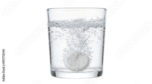 White effervescent tablet dissolves in clear glass of sparkling water creating dynamic bubbles against black background highlighting a refreshing chem