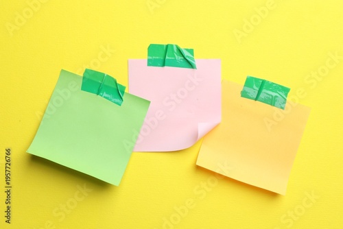 Reminder. Sticky notes on yellow background, top view