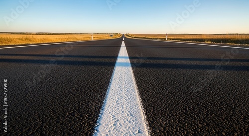 Endless Asphalt Highway Stretching Towards Distant Horizons Under a Clear Sky