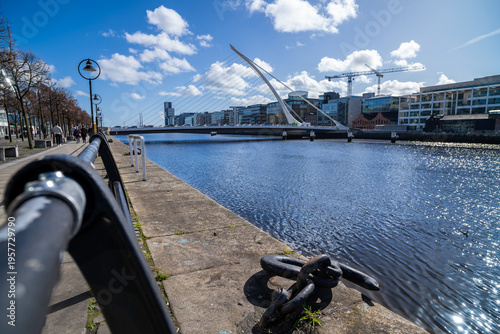 Quayside path follows River Liffey toward Samuel Beckett Bridge and Dublin docklands