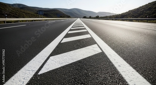 Endless Open Highway Under Vast Mountain Landscape And Sunny Sky
