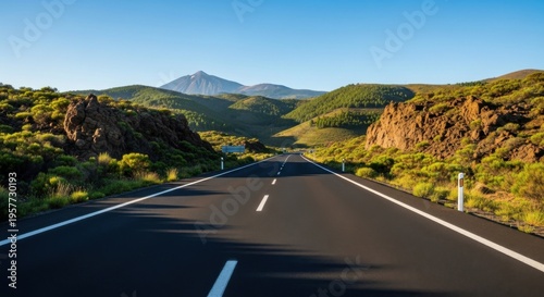 Endless Open Road To Distant Majestic Mountain Peak Under Clear Blue Sky