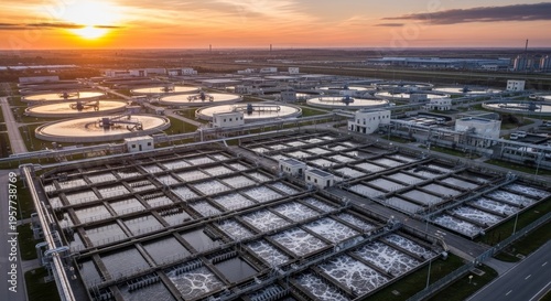 Wastewater treatment plant with circular settling tanks at sunset. Industrial water purification facility for urban ecology and environmental protection. Infrastructure for water management.