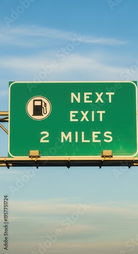 Highway Gas Station Sign Indicates Fueling Opportunity In Two Miles