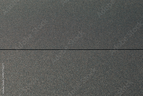 Dark gray textured wall surface with horizontal seam