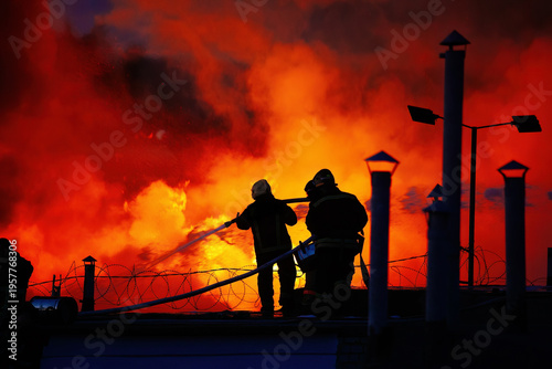 A team of firefighters is extinguishing a fire at an industrial building in the city