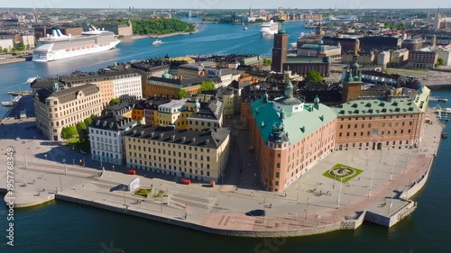 Aerial view of a city center with diverse buildings, waterfront, and cruise ships
