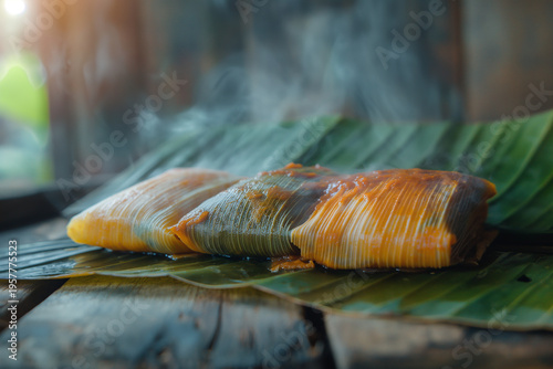 Three steaming tamales rest on banana leaves, golden-brown and inviting