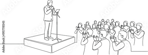 man speaking to a crowd from a podium