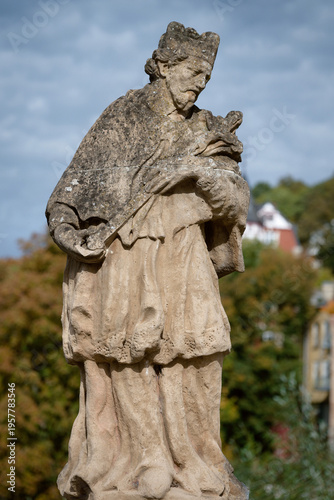 Historic sandstone statue of St. Nepomuk at the confluence of Urft and Olef rivers. Located at Platz am Nepomuk, Gemünd, Eifel region