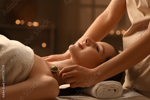Young woman having neck mas...