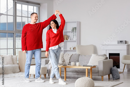 Young couple in warm red sw...
