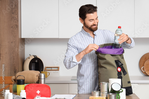 Young man packing emergency...